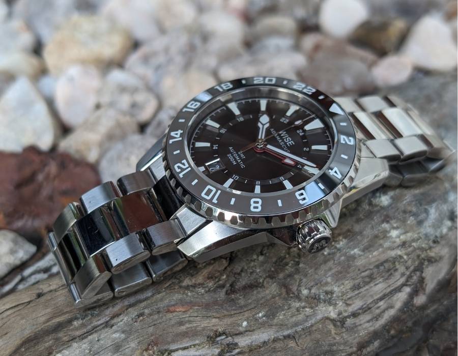 WISE ADX 110 True GMT stainless steel watch with detailed side view highlighting case, bezel, and bracelet