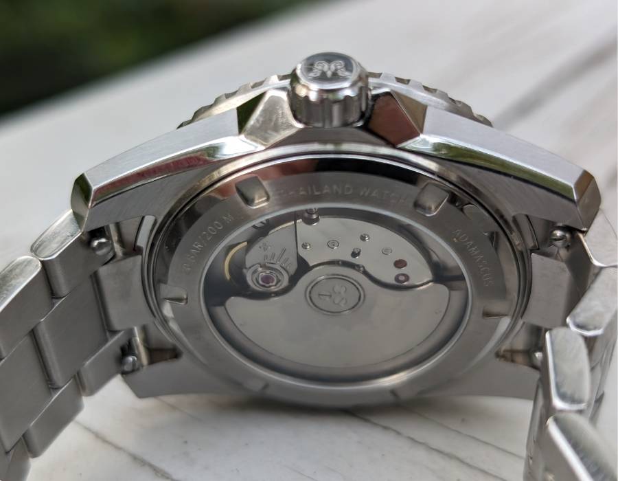 Caseback view of WISE ADX 110 True GMT showing automatic movement and stainless steel bracelet